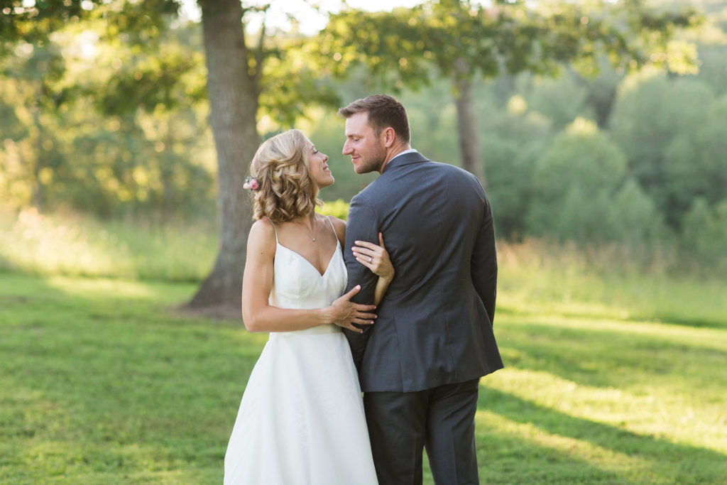 Barn at Turkey Ridge Wedding | Sunset wedding portraits | Bride and groom linking arms