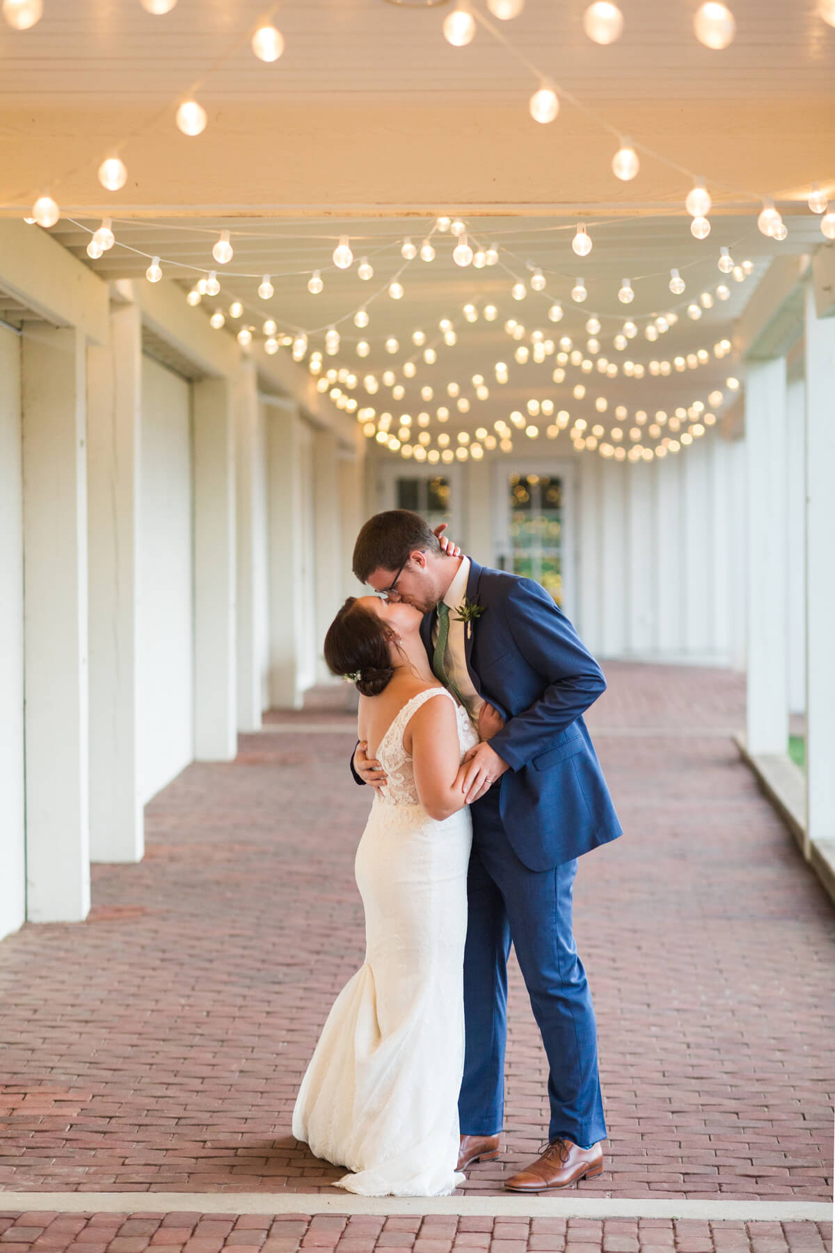 Kissing under string lights | Fall Wedding at King Family Vineyards by Virginia Photographers