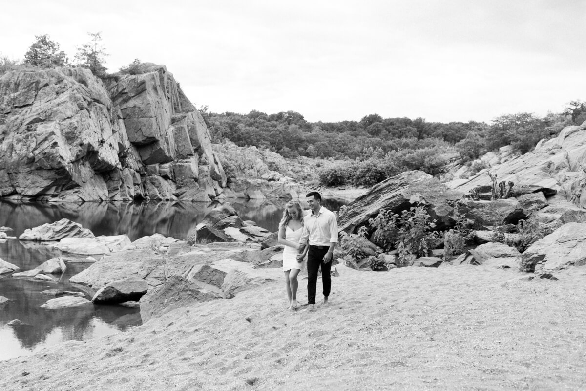 Couple walking along private beach at Great Falls