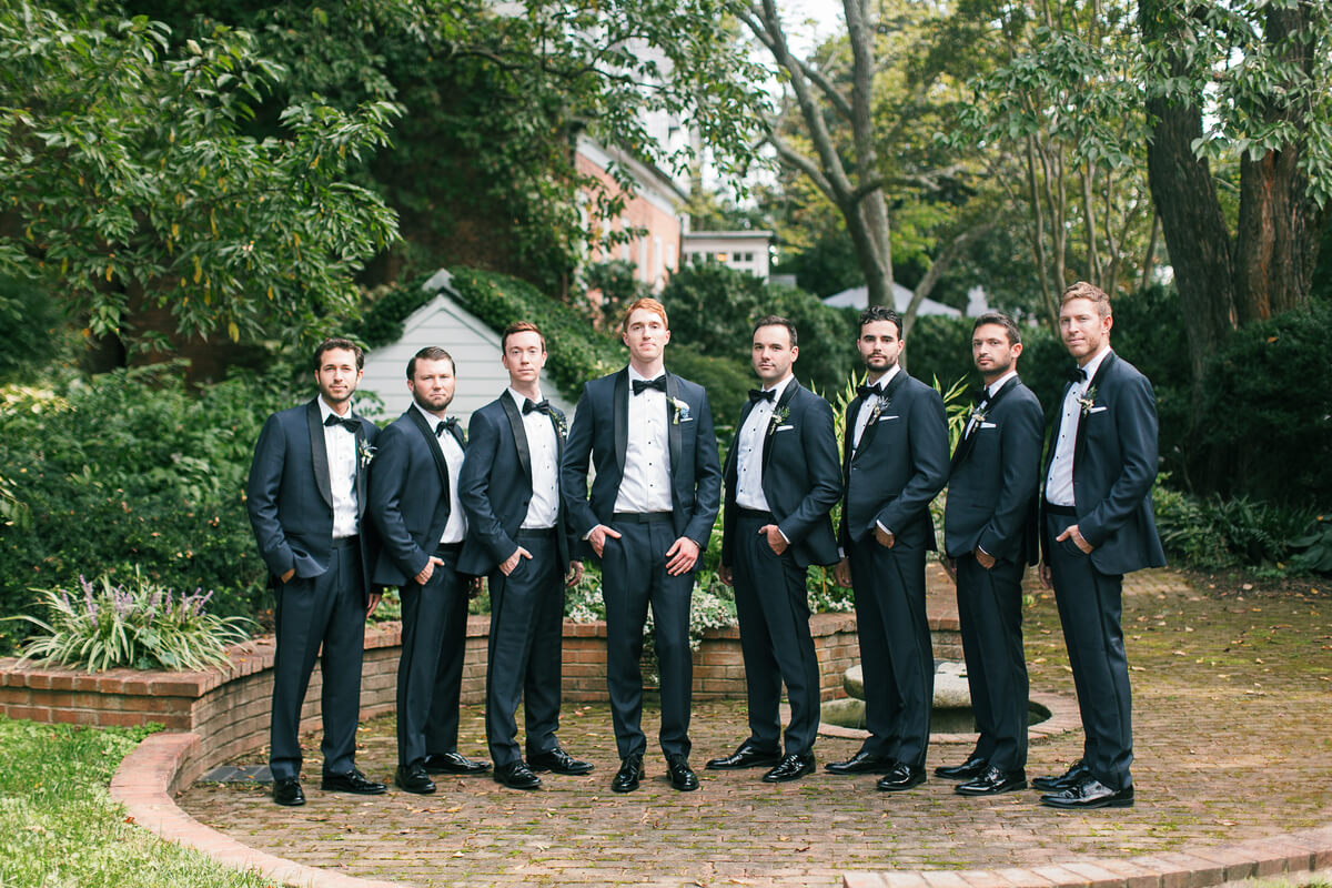 Groom and groomsmen in navy tuxedos